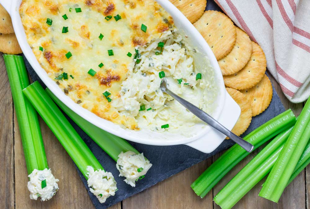 Baked crab dip, served with celery sticks and crackers