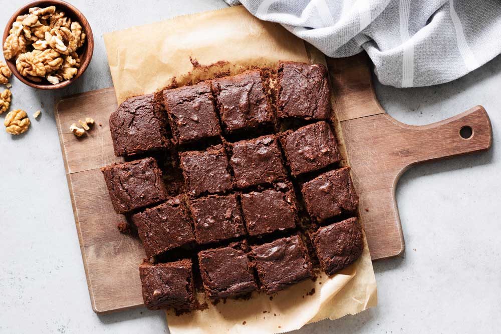 Chocolate brownie squares on cutting board