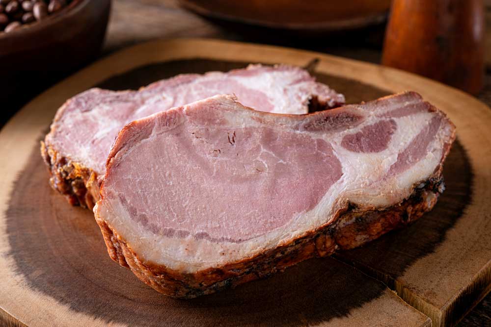 Delicious smoked pork chops on a rustic wood cutting board