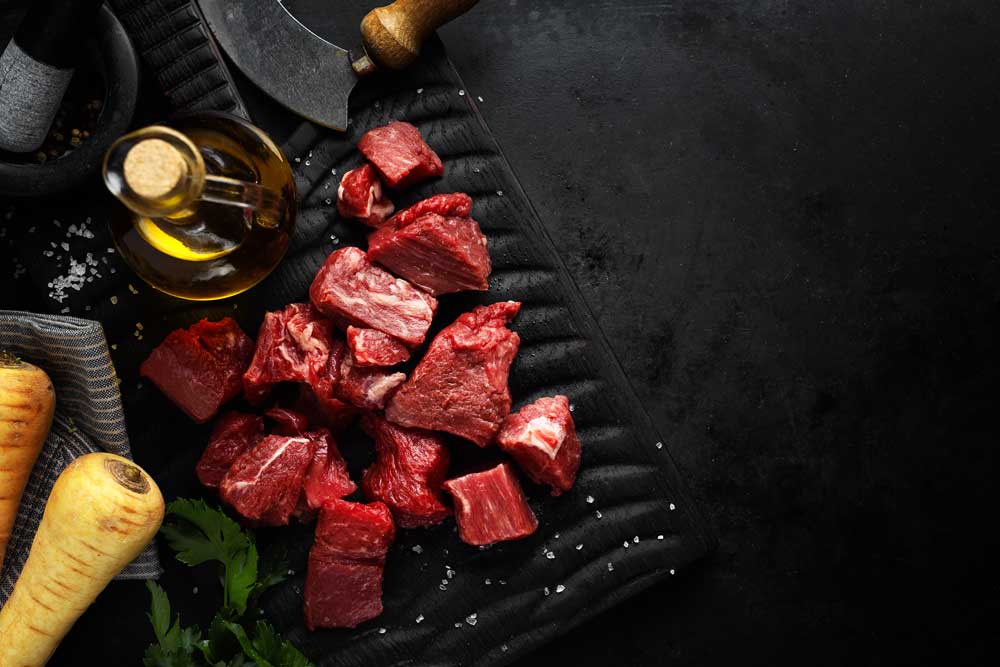 Fresh beef chunks served on table with ingredients ready for cooking
