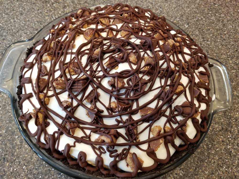 Homemade peanut butter cream pie with chocolate drizzle