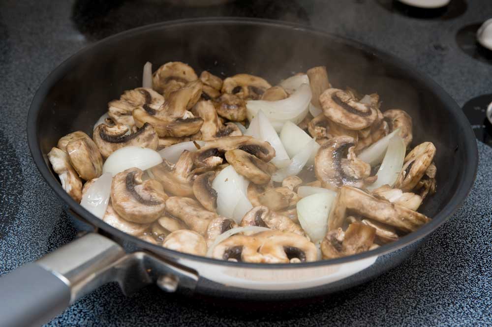 Sauteed mushrooms and onions in a skillet