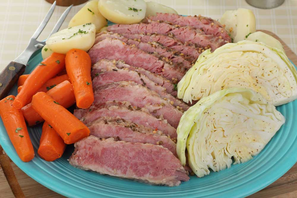 Sliced corned beef brisket with cabbage, carrots and potatoes