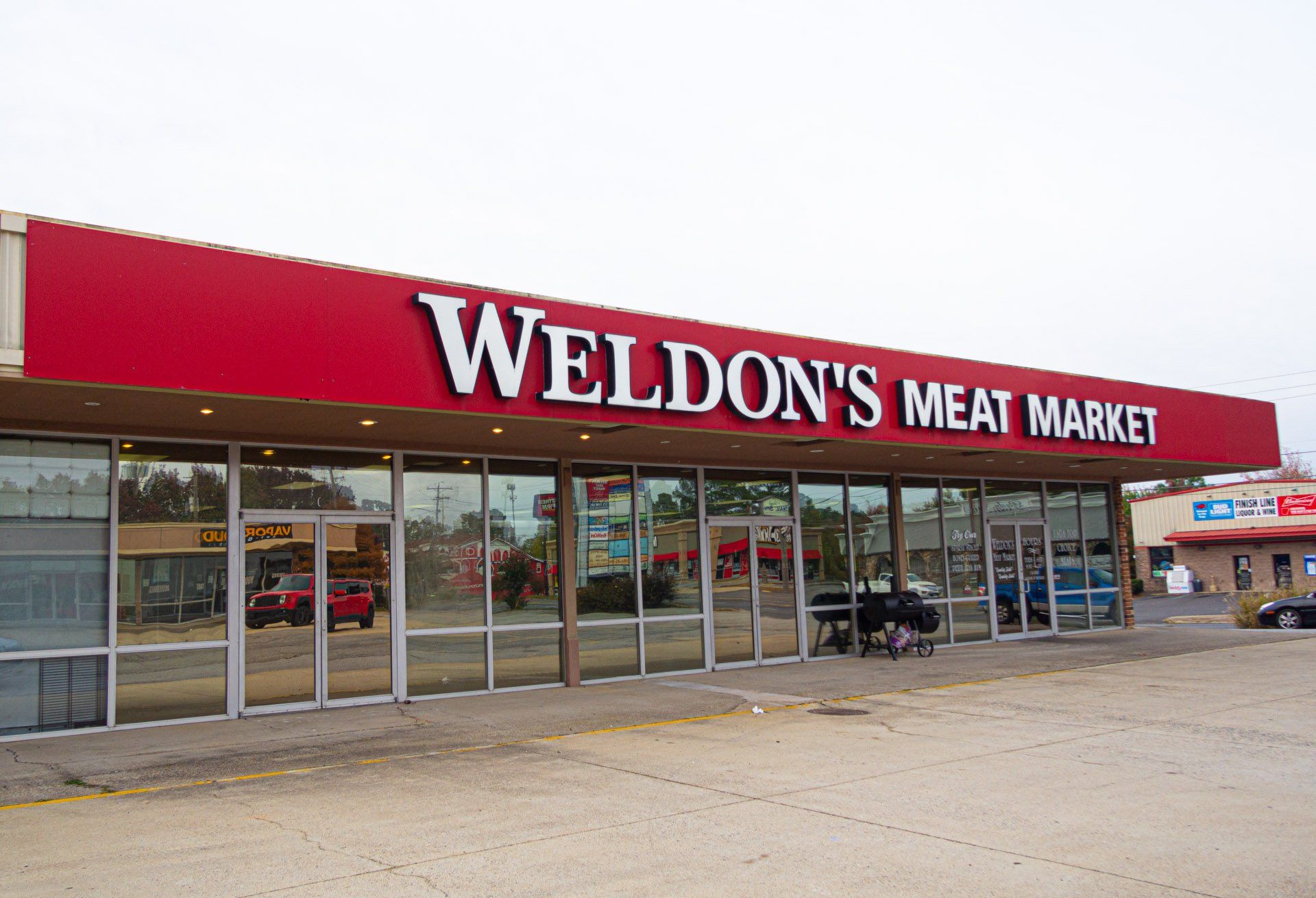 A weldon 's meat market with a red sign