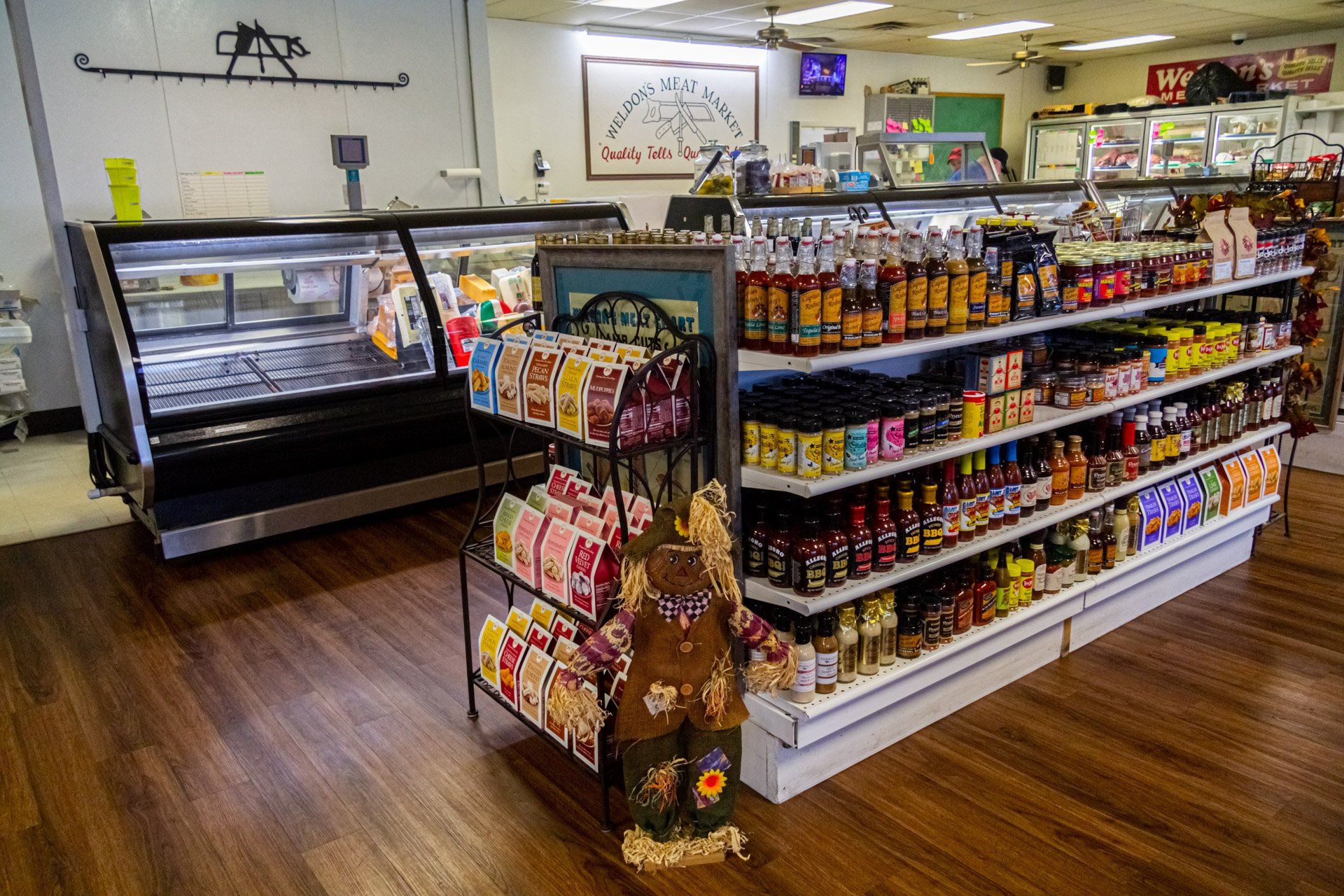 A grocery store with a lot of shelves and a display case.