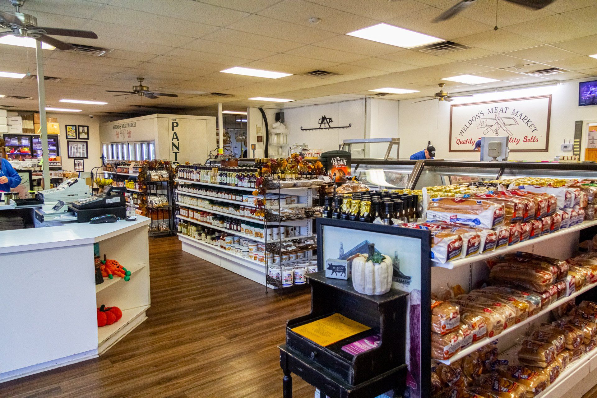 A grocery store filled with lots of shelves of food and a piano.