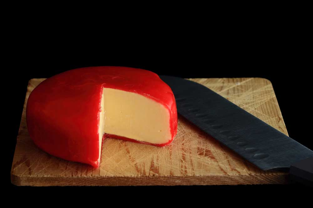 Wheel-of-Gouda-Cheese-covered-with-red-wax-protective-layer