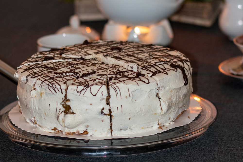 cream cake with pear filling served on a nicely laid table