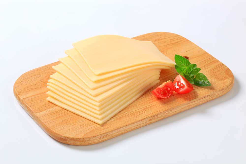 thin-slices-of-a-fresh-cheese-on-a-wooden-cutting-board