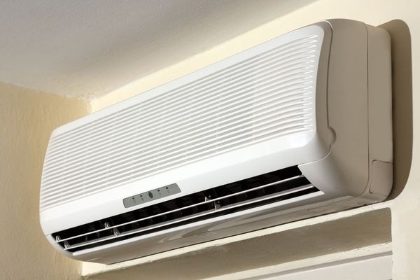 A White Air Conditioner Is Mounted On A Wall — Vertex Refrigeration & Air Conditioning Pty Ltd In Cannonvale, QLD