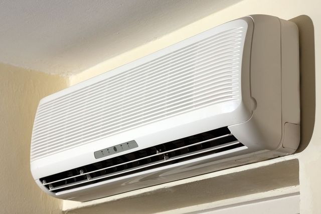 A White Air Conditioner Is Mounted On A Wall — Vertex Refrigeration & Air Conditioning Pty Ltd In Cannonvale, QLD
