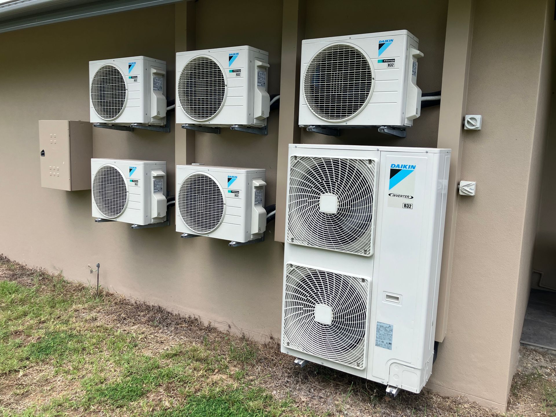 Air Conditioners Are Sitting Outside Of A Building — Vertex Refrigeration & Air Conditioning Pty Ltd In Cannonvale, QLD