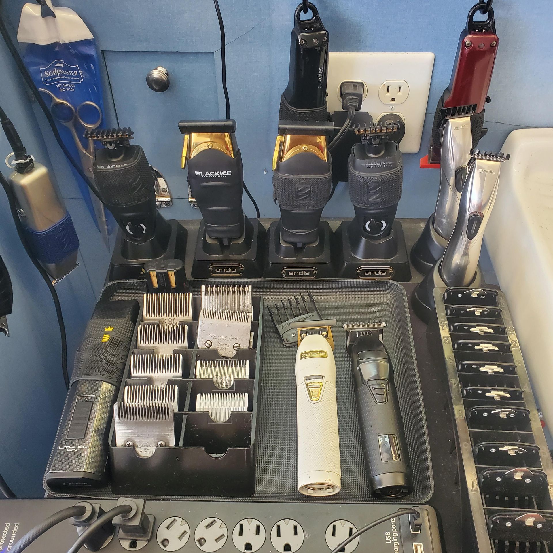 A bunch of hair clippers are sitting on a table