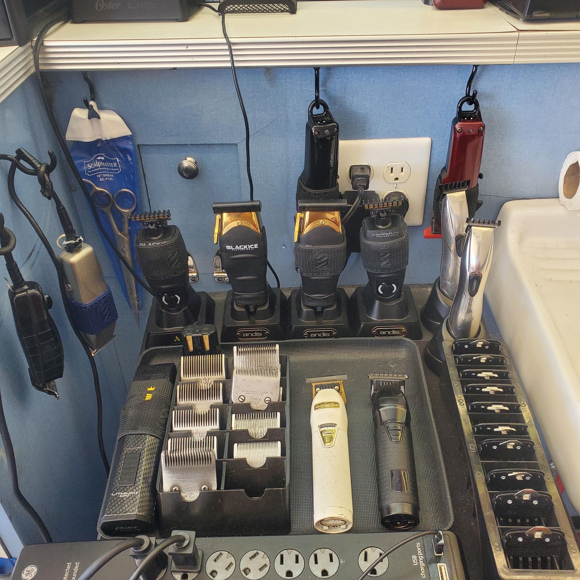 A bunch of hair clippers are sitting on a table