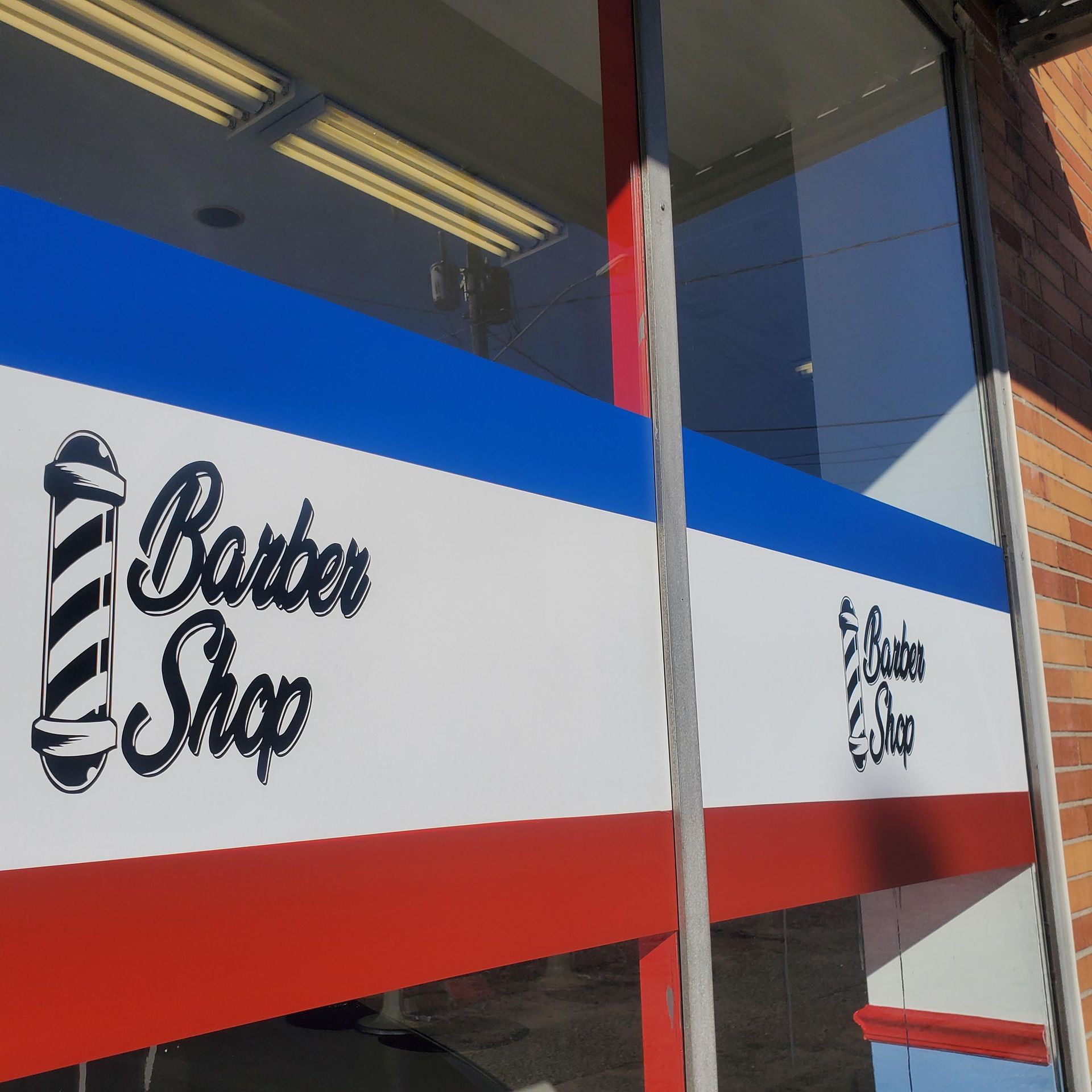 A red white and blue sign for a barber shop