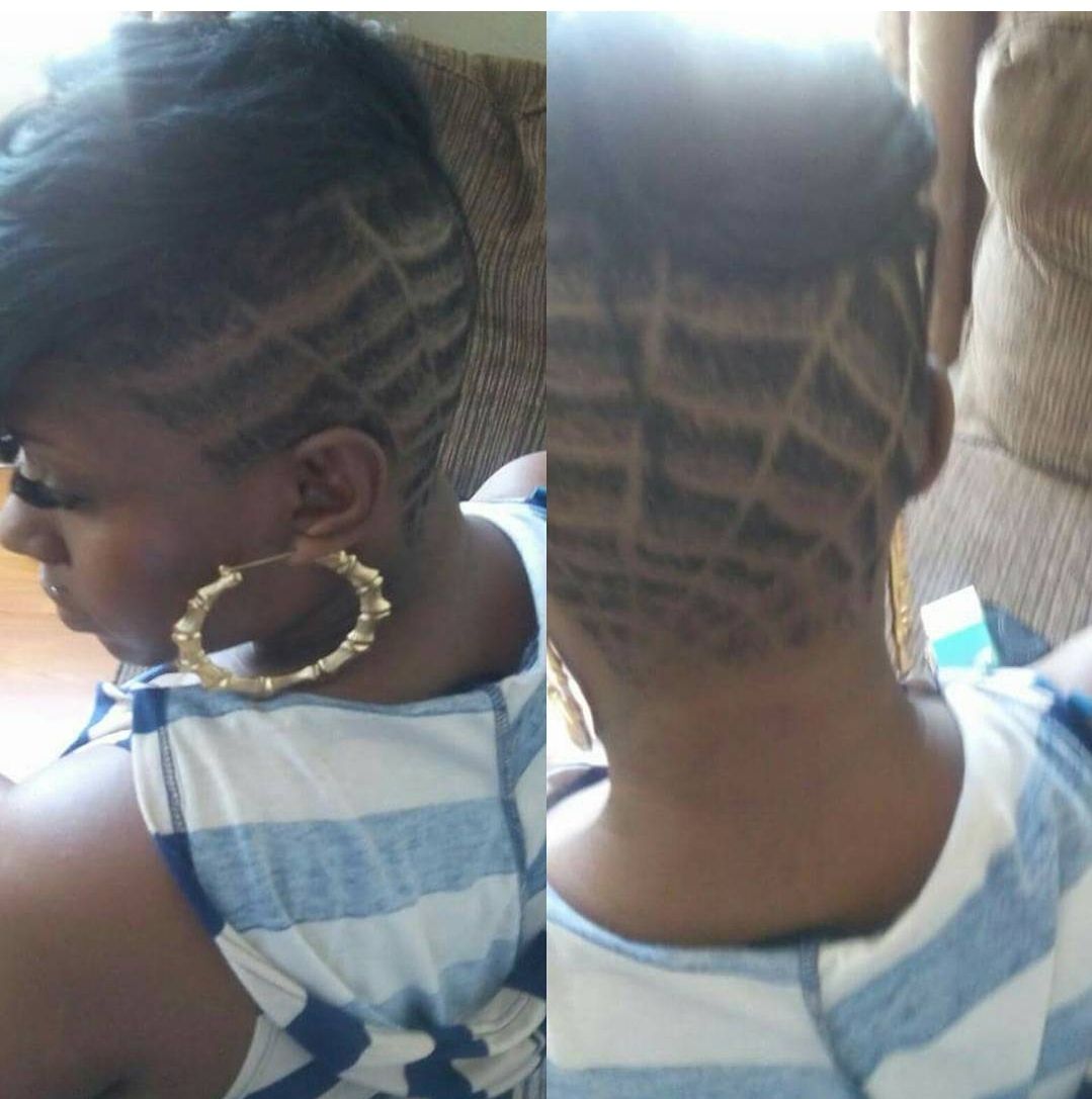 A woman with a shaved head and hoop earrings