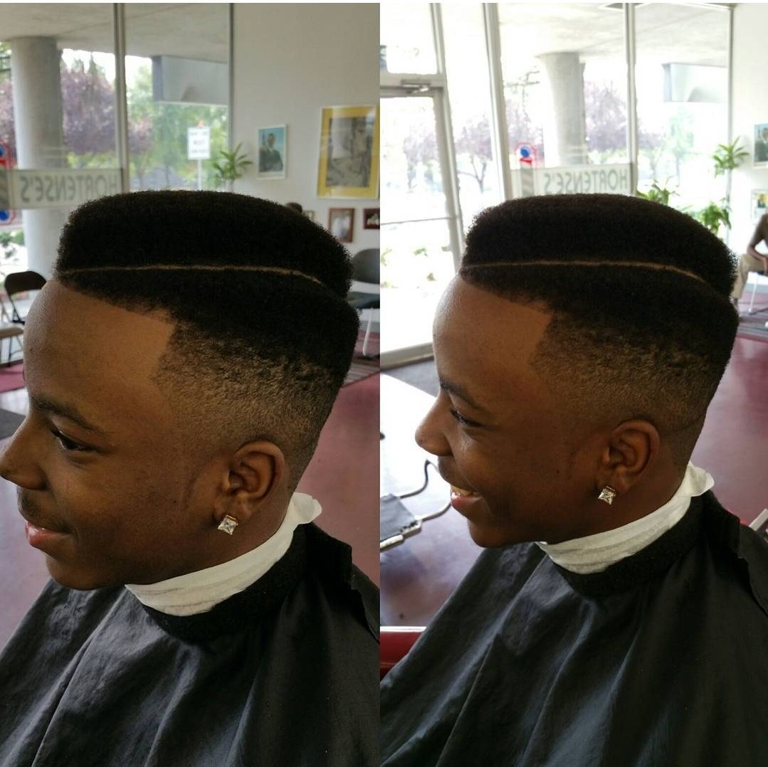 A man is getting his hair cut at a barber shop