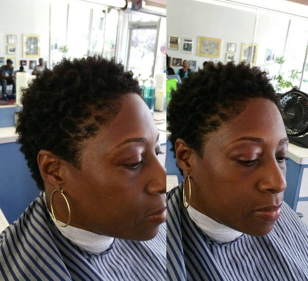 A woman is getting her hair cut in a salon