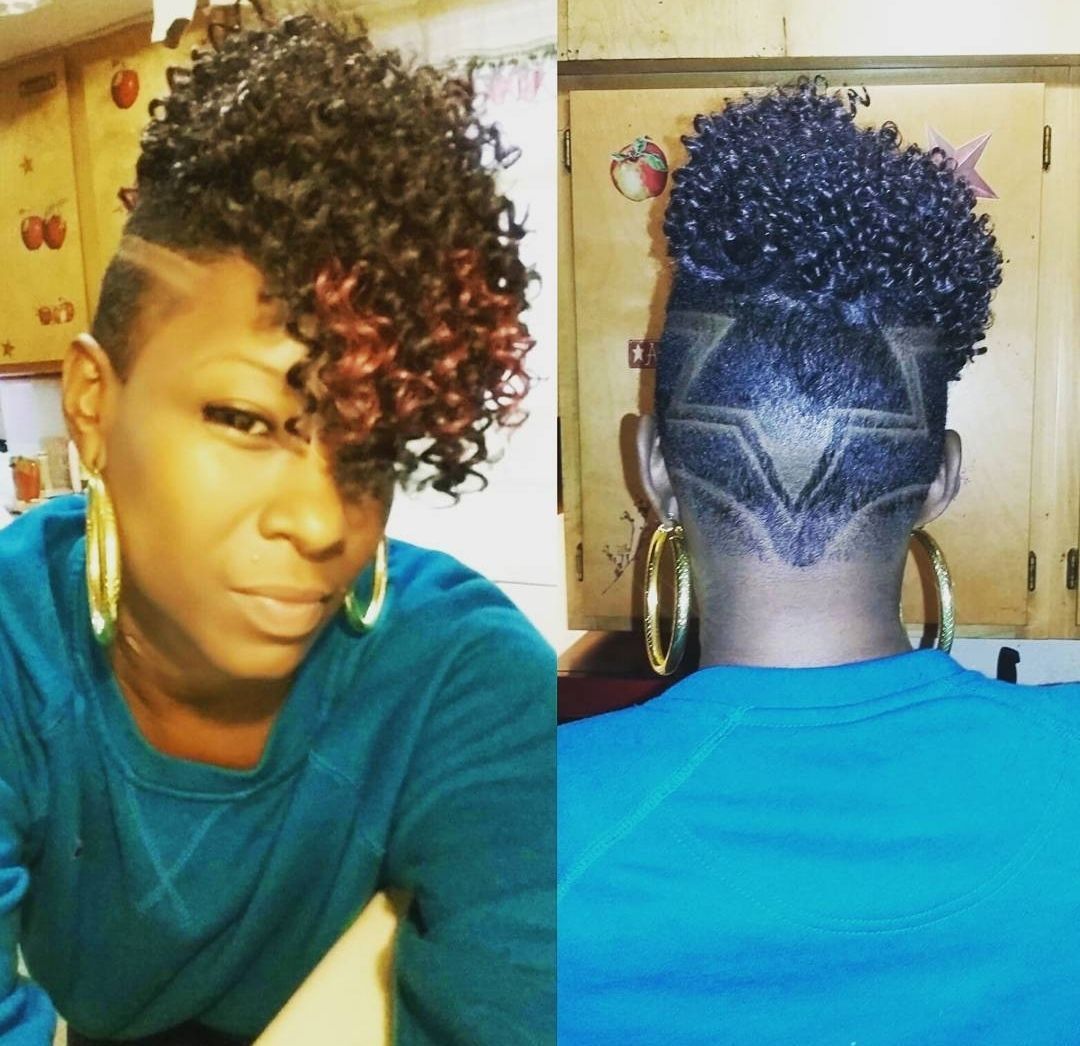 A woman with curly hair is wearing a blue shirt