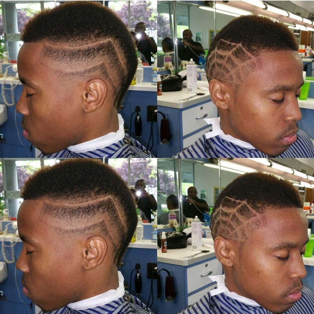 A man is getting his hair cut at a barber shop