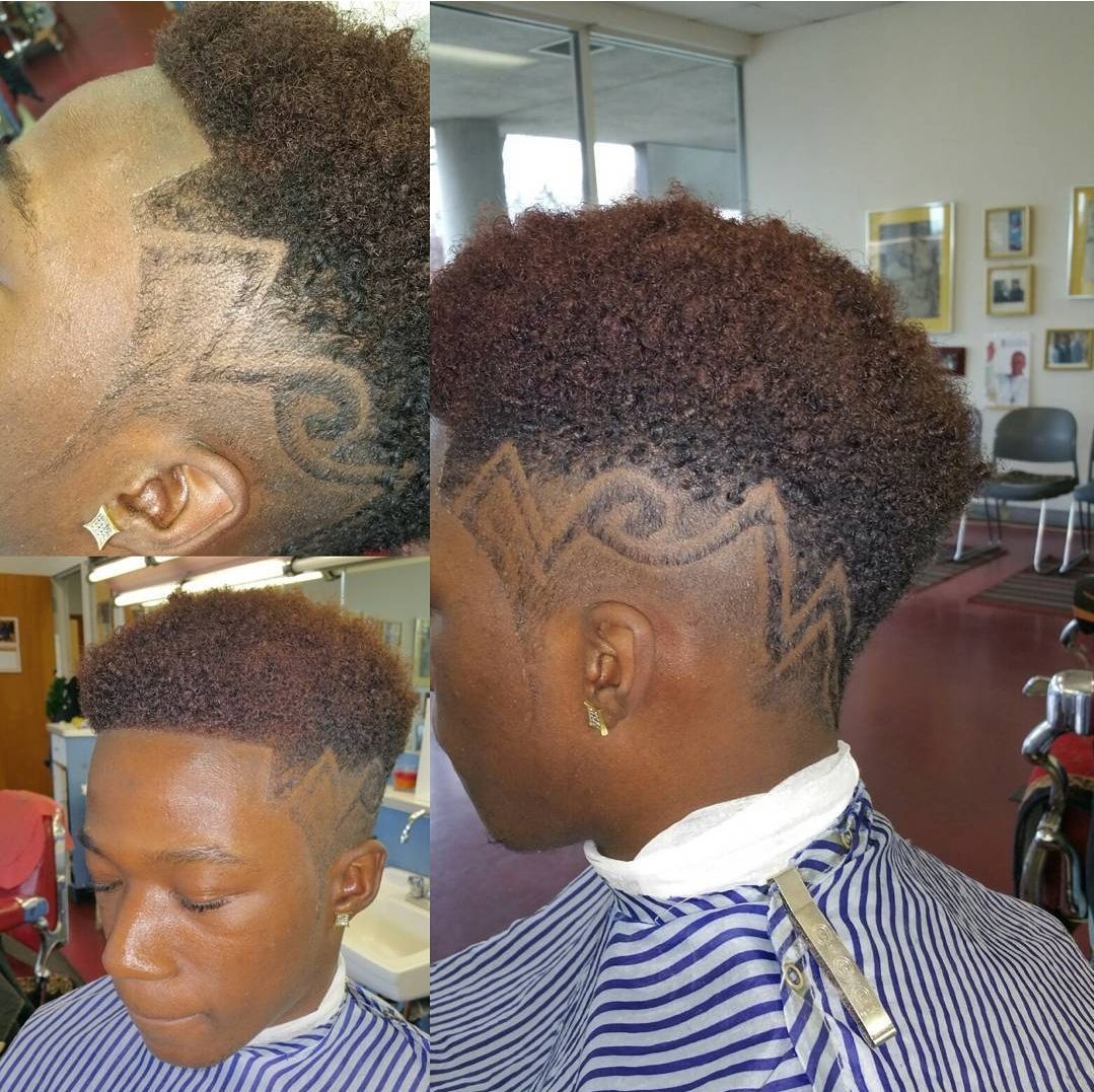 A man is getting his hair cut in a barber shop