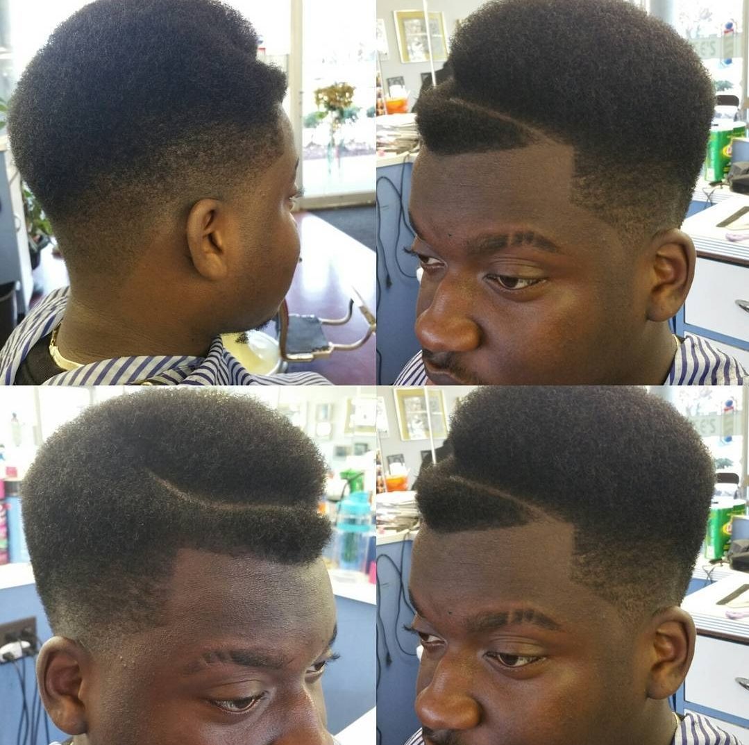 A man is getting his hair cut in a barber shop