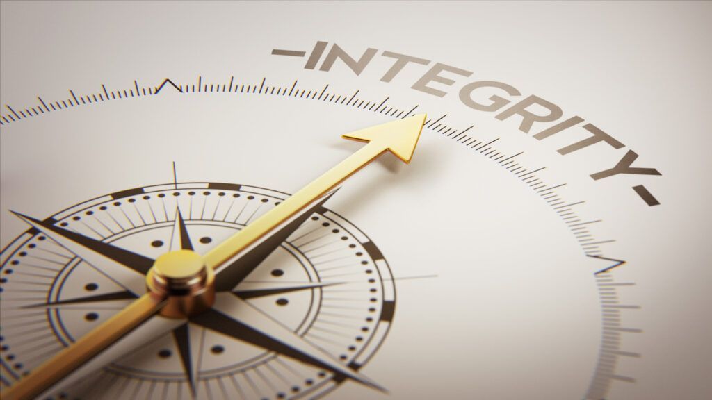 A gold compass needle points to the word 