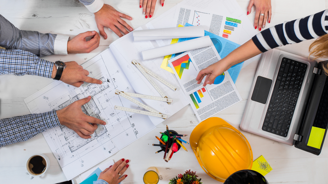 A group of people are sitting around a table working on a project.