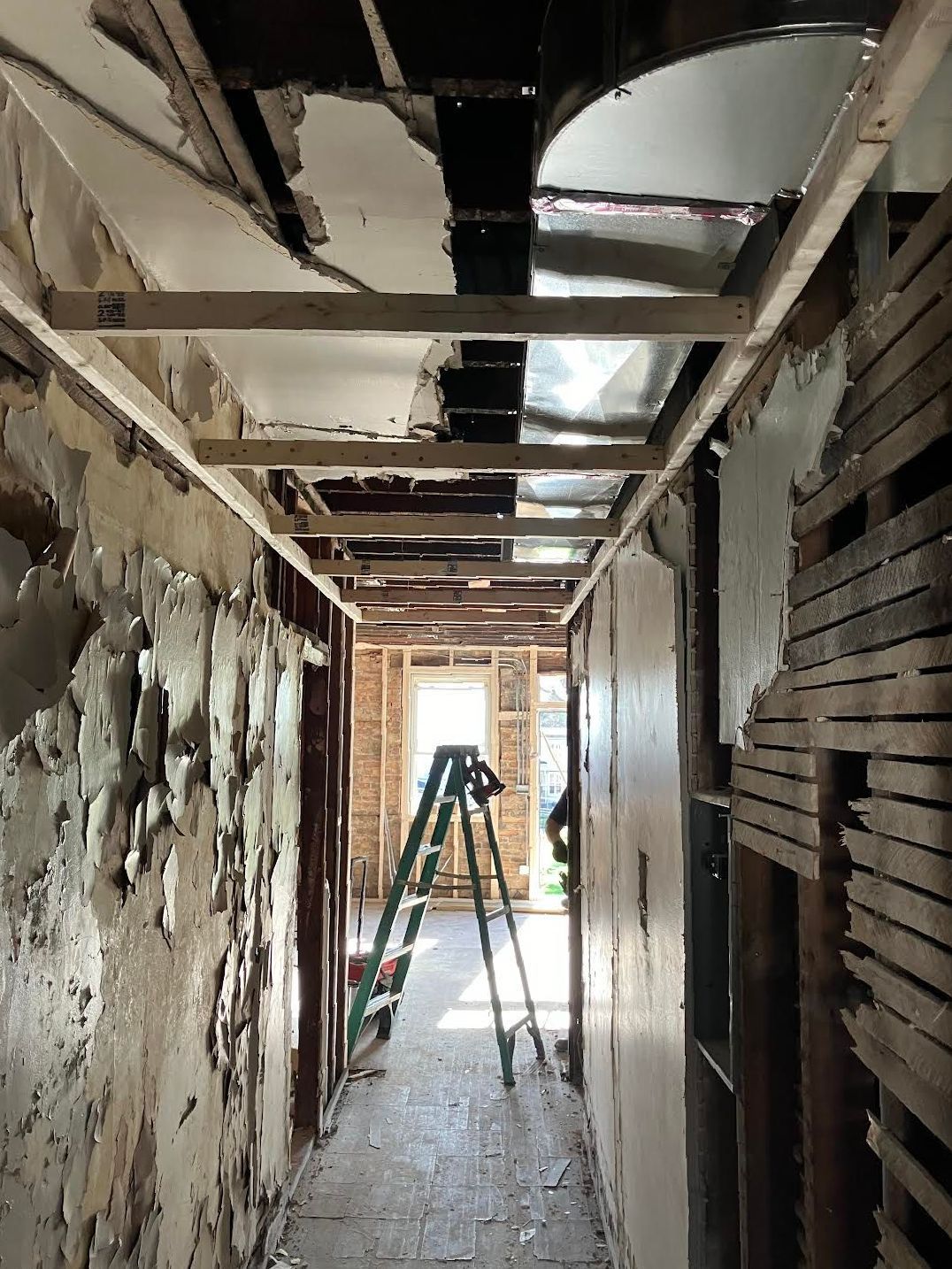 A building under construction with boxes and a ladder