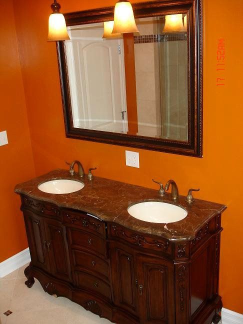 A bathroom with two sinks and a mirror