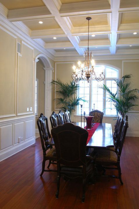 A dining room with a table and chairs and a chandelier