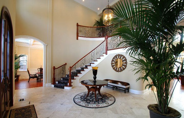 A house with a clock on the wall and stairs
