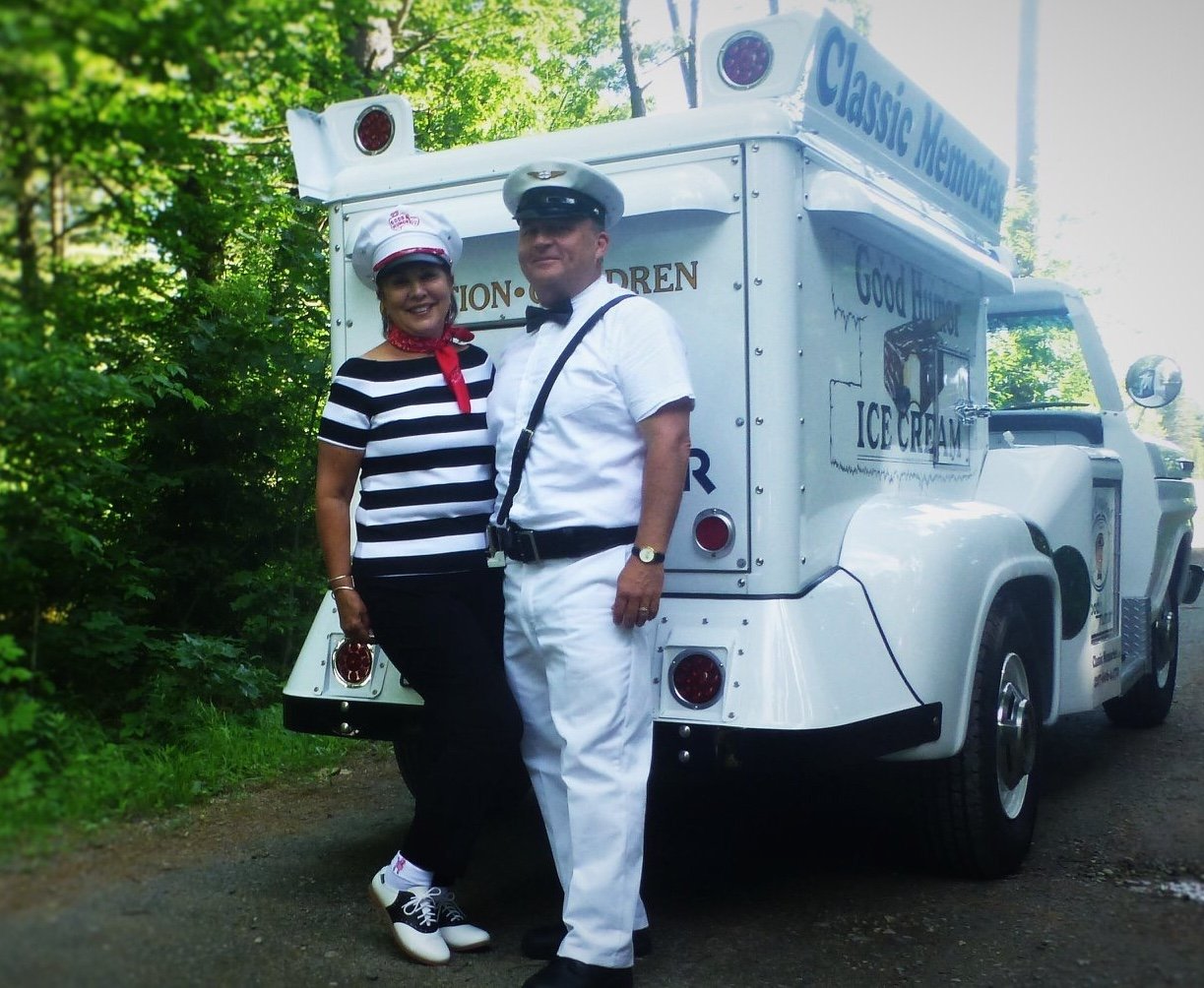 two adults standing in front of ice cream truck