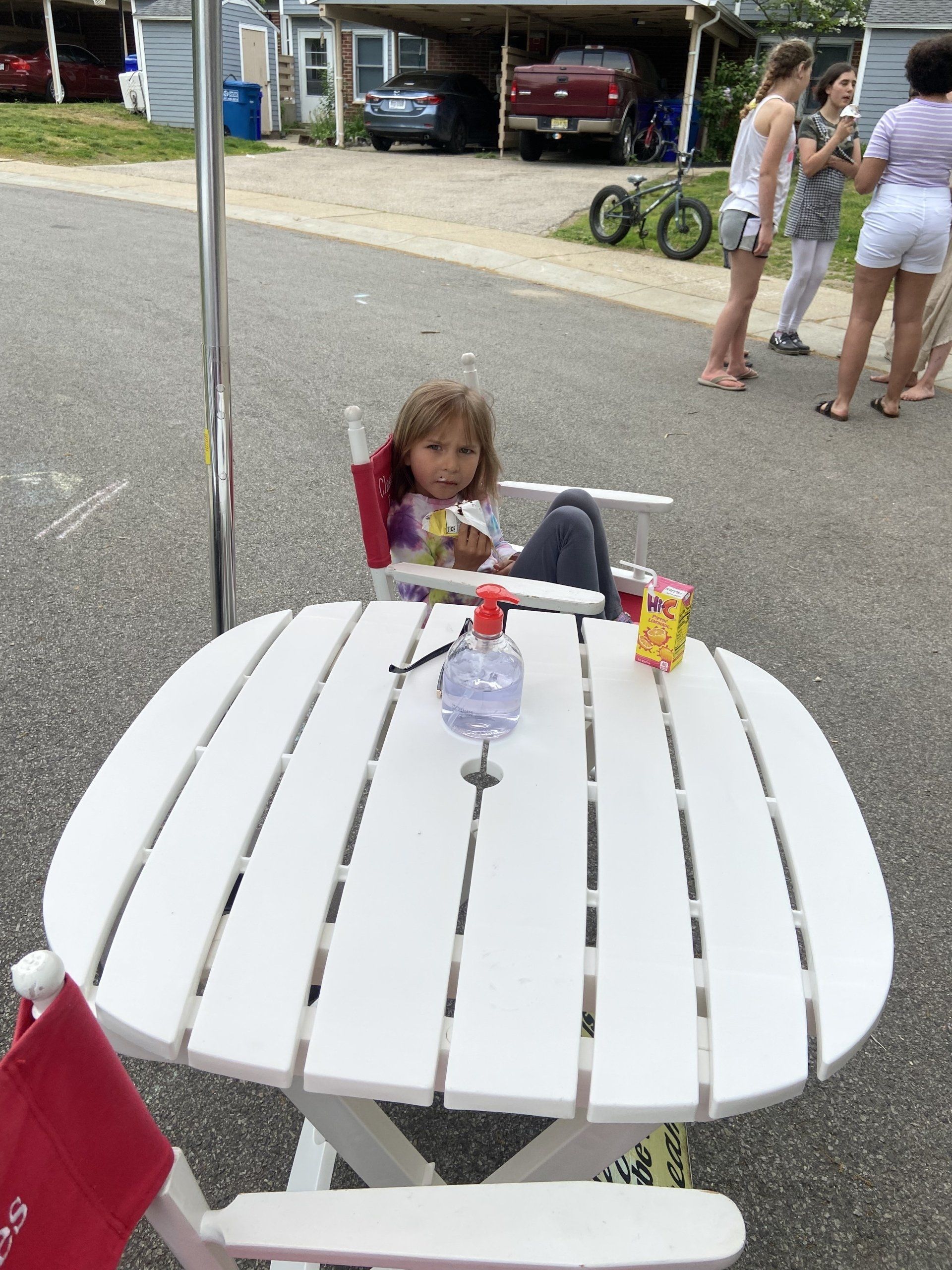 child sitting at picnic table