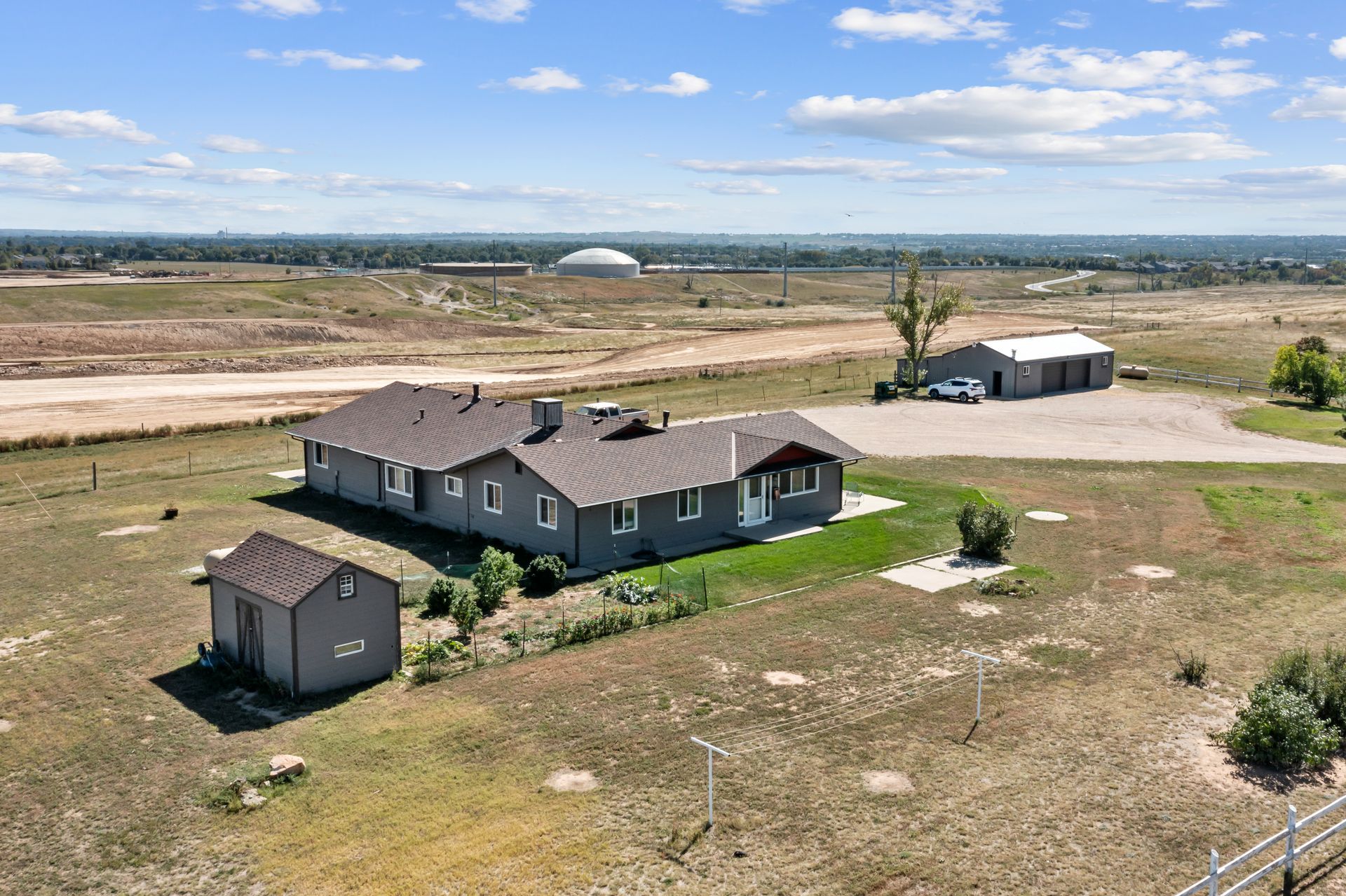 an aerial view of a house in the middle of a field