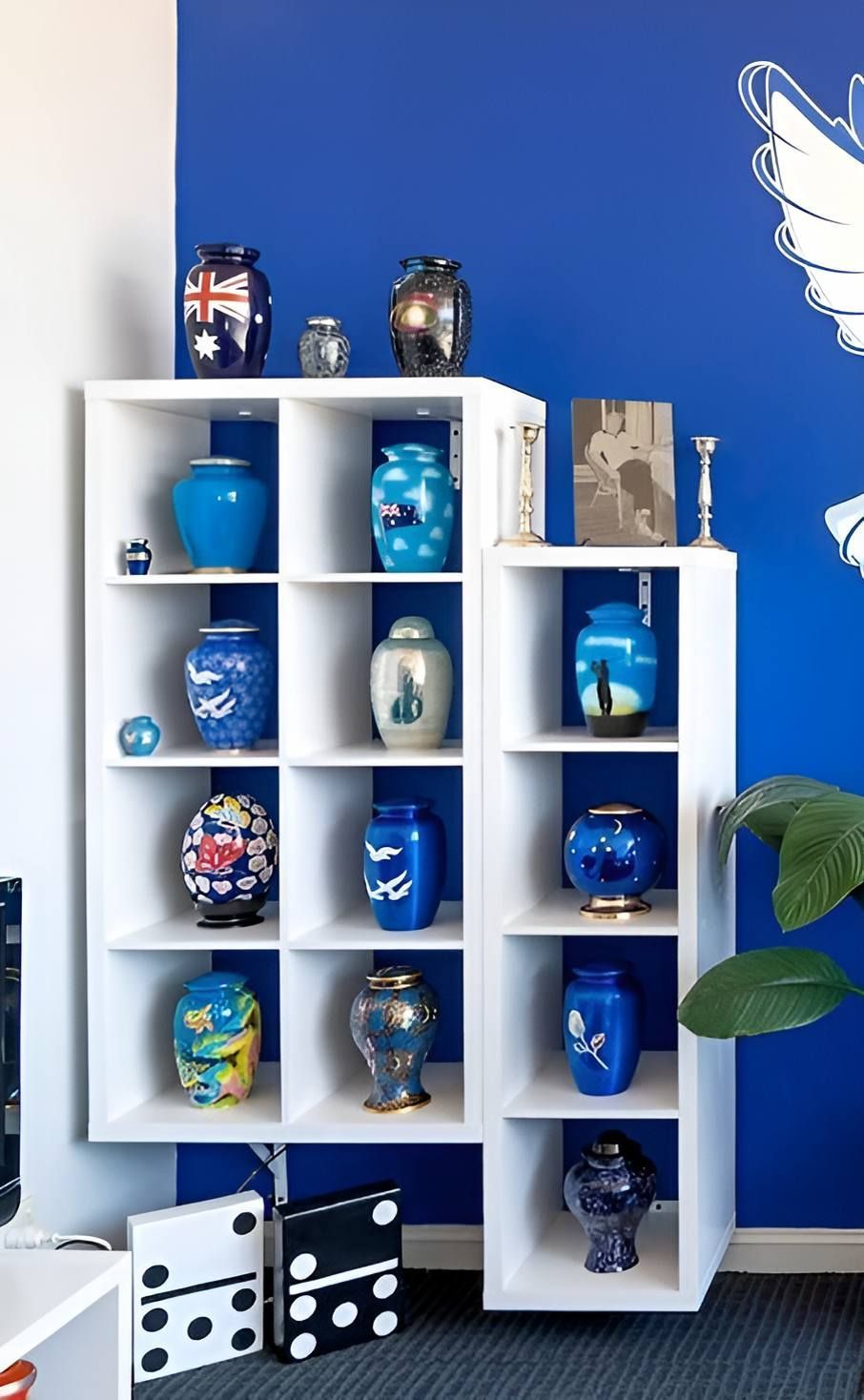 A Room With Blue Walls and White Shelves With Blue Vases — Mid Coast Funeral and Cremation Service In Port Macquarie, NSW