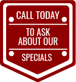 A red sign that says `` call today to ask about our specials ''.