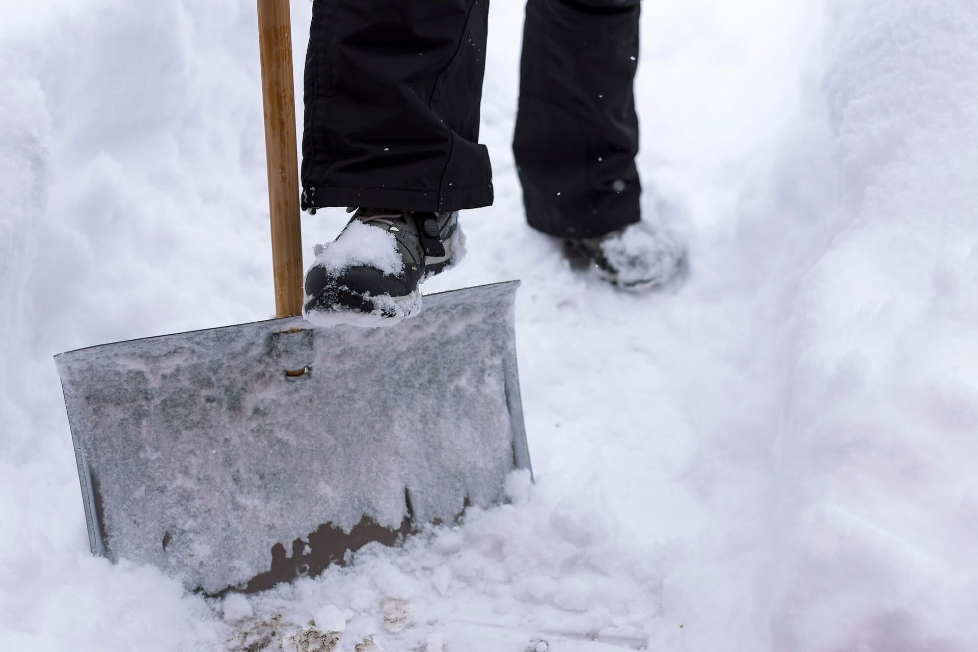 A person is shoveling snow with a shovel in the snow.