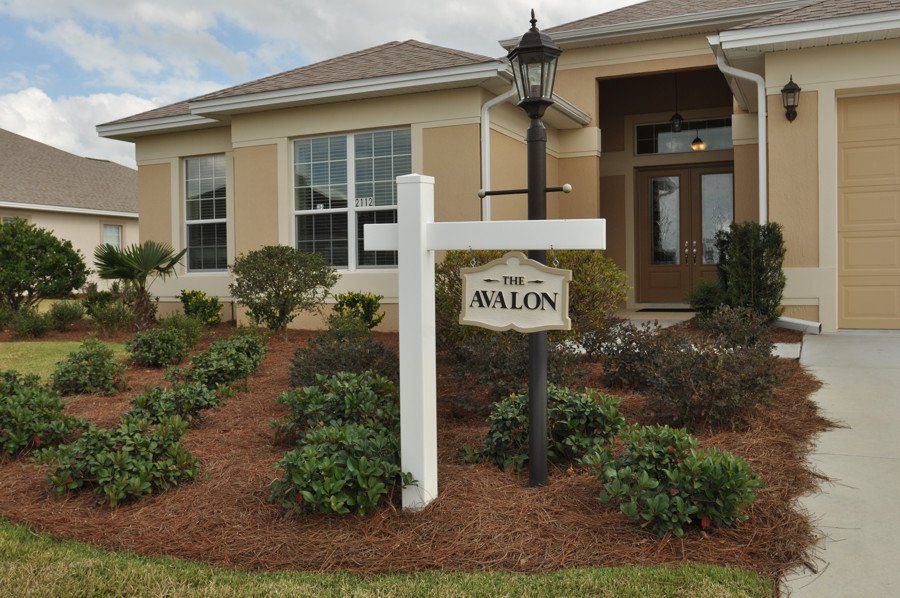 A house with a sign in front of it that says avalon