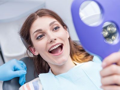 Woman smiling at her teeth