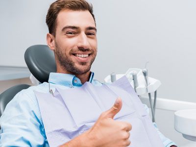 man smiling and showing thumb 