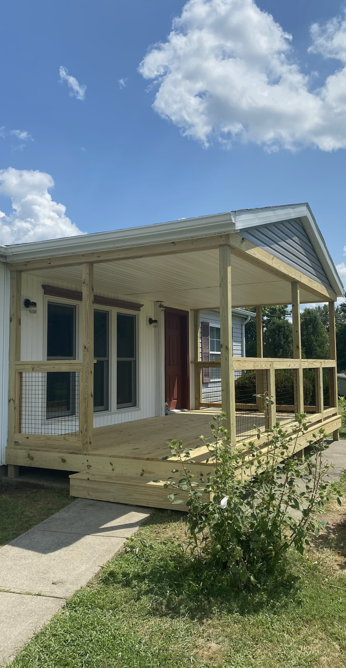 A porch is being built on the side of a house.
