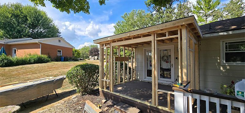 A porch is being built on the side of a house.