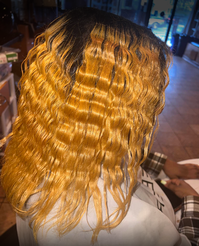 A woman is getting her hair done in a salon.