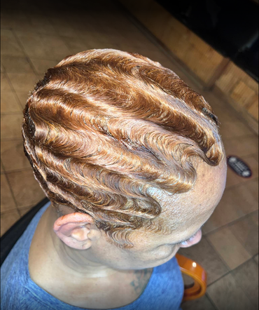 A woman is getting her hair done in a salon.