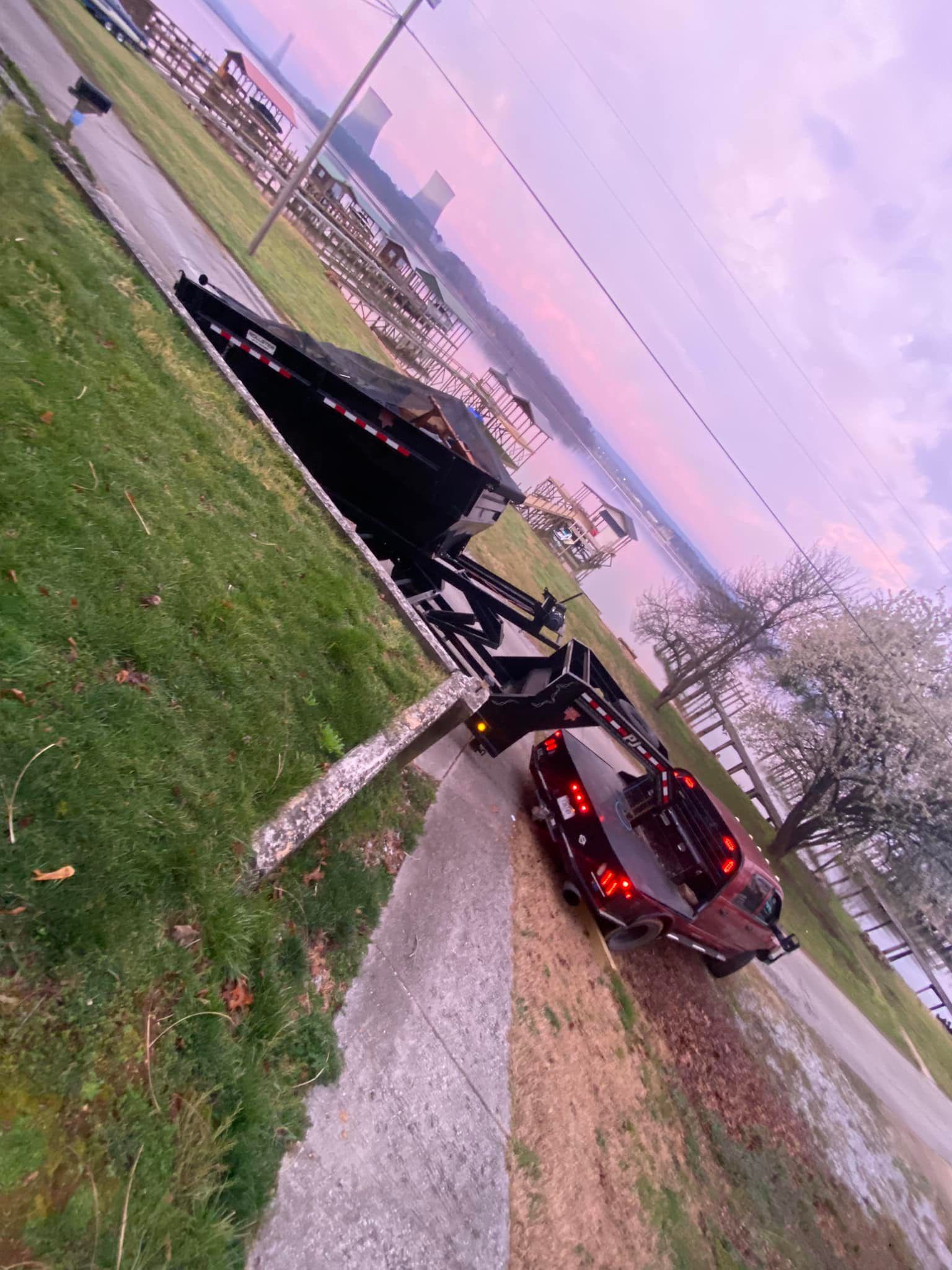A car is parked on the side of a road next to a lake.