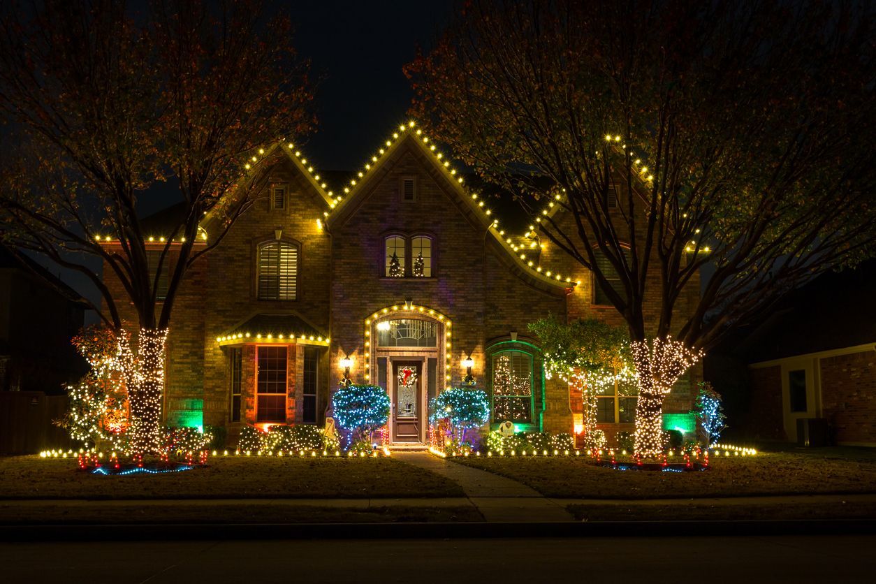 House decorated with bright colorful Christmas lights at night.