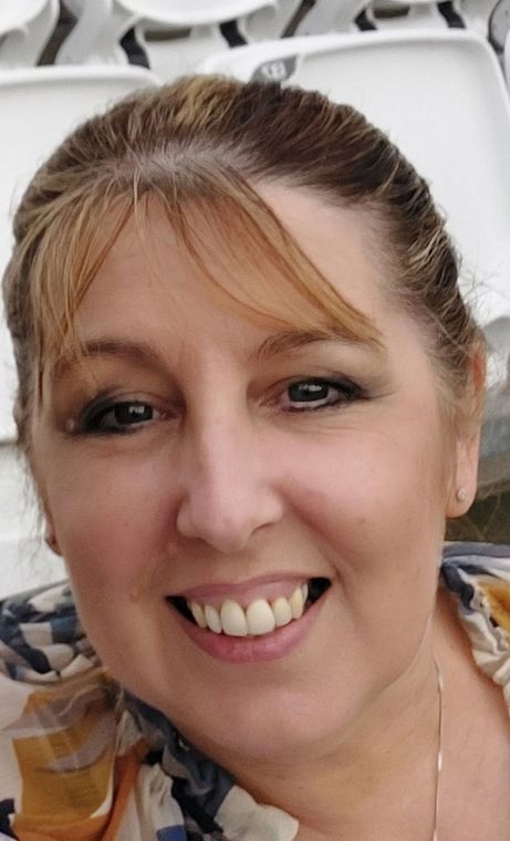 A close up of a woman 's face with a smile on her face