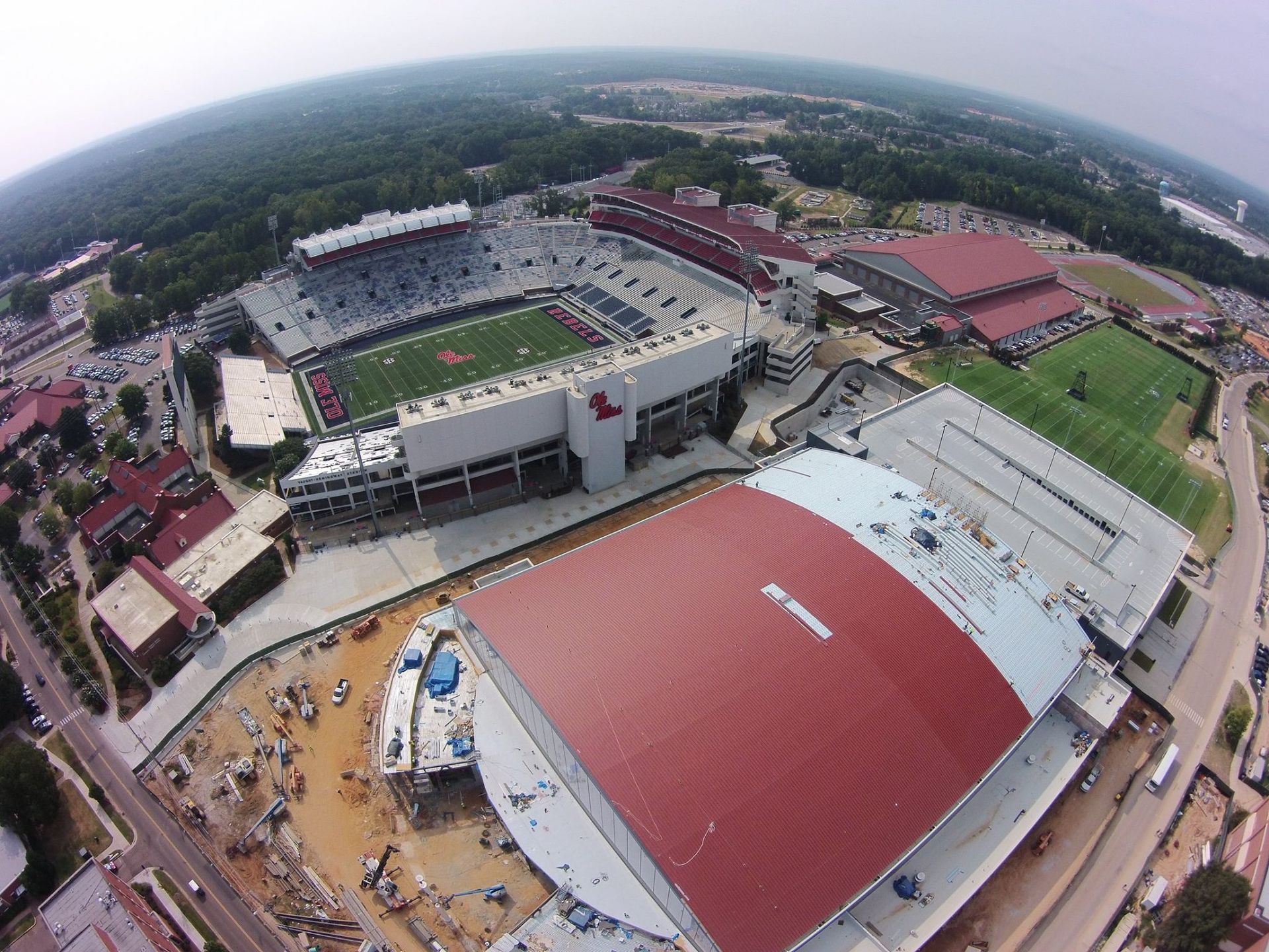 An aerial view of a stadium with a red roof