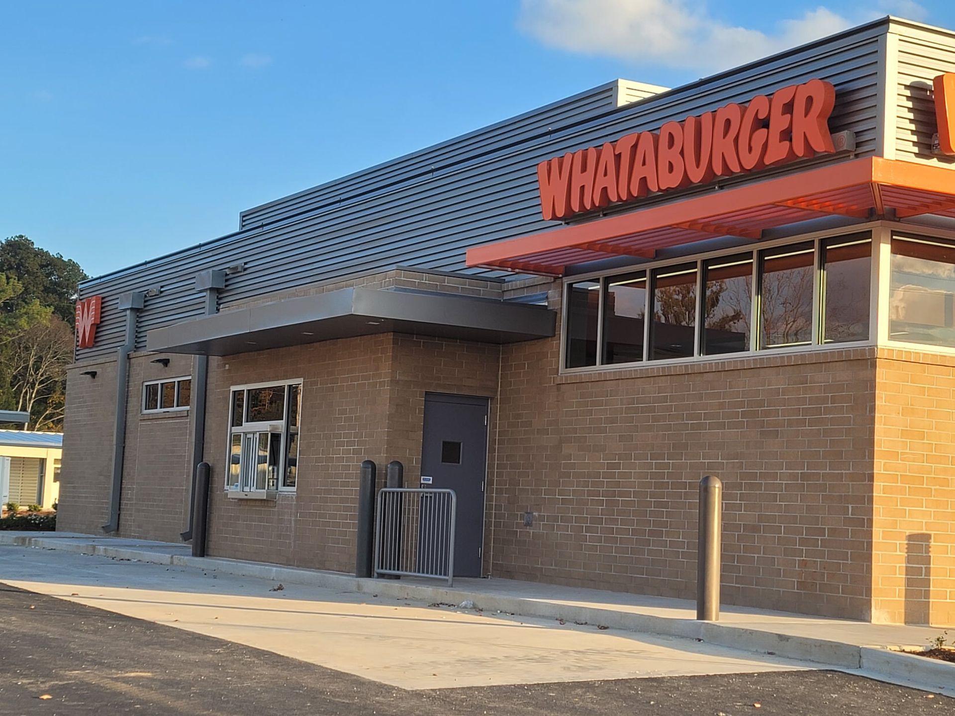 A brick building with a sign that says whataburger